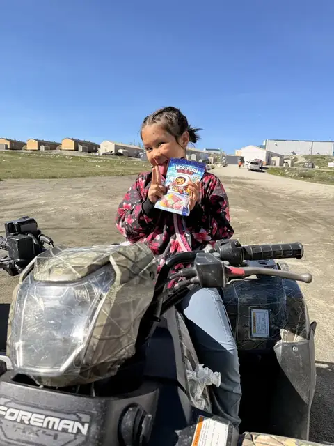 Girl on ATV with Northern Sweets bag